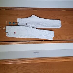 Two white men's painter pants. First pair is 38x32. Second pair is 38x30.